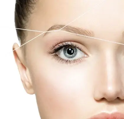 Close-up of eyebrow threading