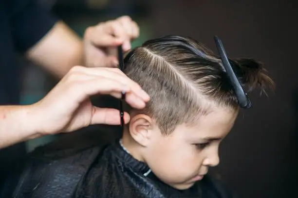 Detailed clipper work during a short haircut
