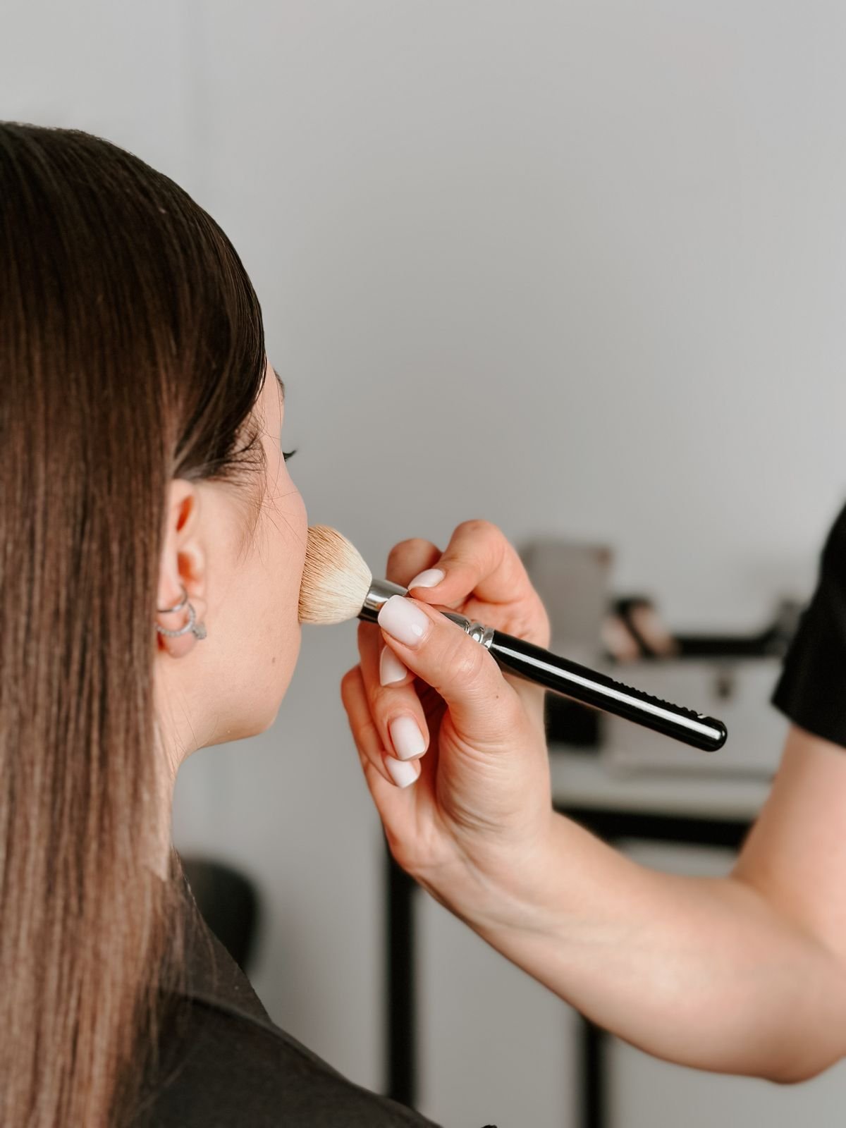 Makeup being carefully applied with a soft brush