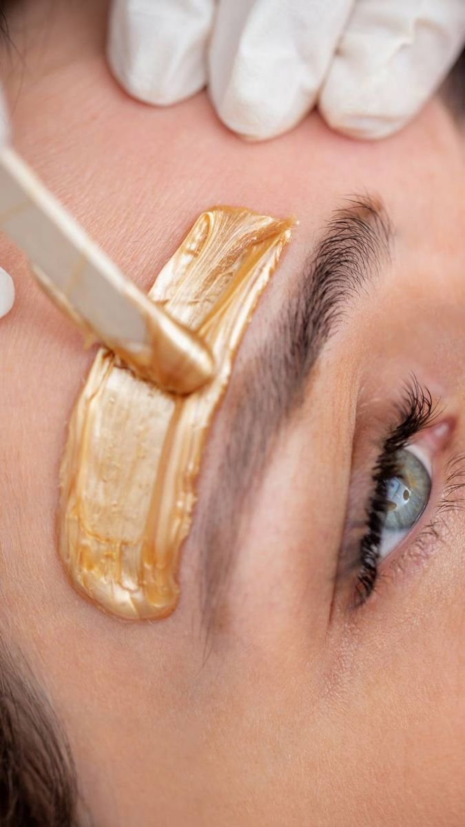 Precise facial waxing near the eyebrow